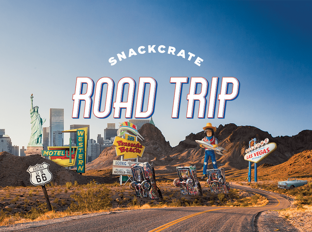 Red, white, and blue text that reads 'SnackCrate Road Trip' with a background collage of famous American landmarks such as the Statue of Liberty, the Route 66 highway sign, and the Welcome to Las Vegas sign.